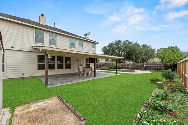 a view of an house with backyard space and sitting area