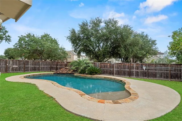 a view of a backyard with swimming pool