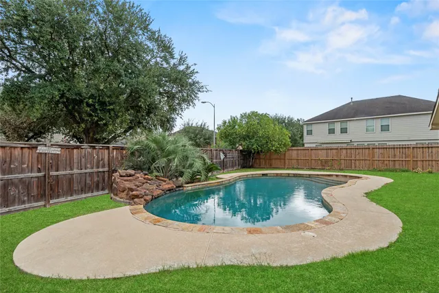 a view of a backyard with swimming pool