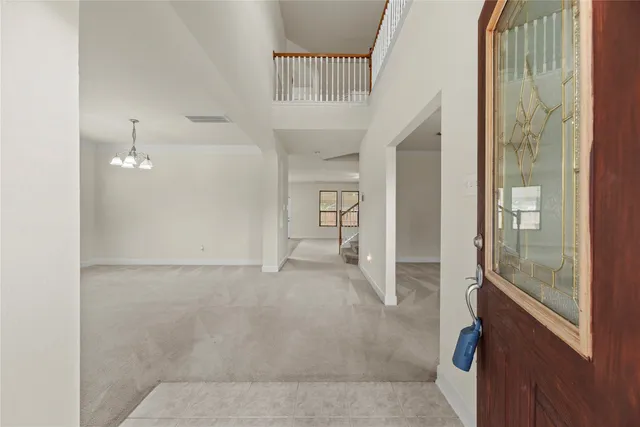 a view of a hallway with wooden floor and a living room