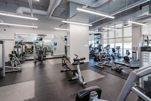 a kitchen with stainless steel appliances granite countertop a refrigerator stove and sink