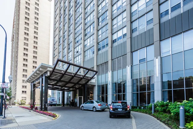 a bedroom with bed and a large window