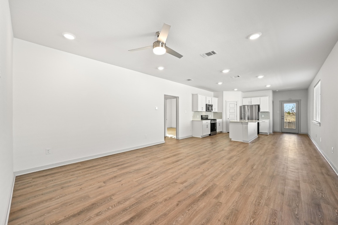 407 Wilshire Road San Marcos, TX 78666 - Photo 7 of 25 a view of large kitchen with a wooden floor and window
