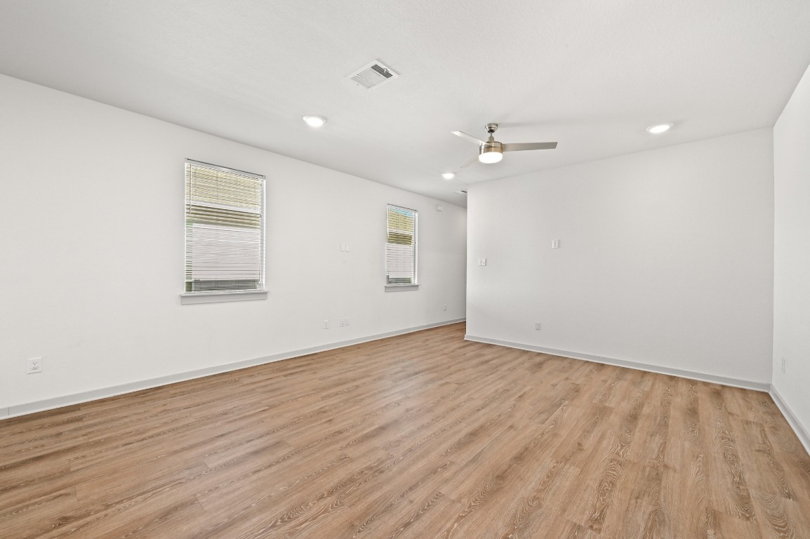 407 Wilshire Road San Marcos, TX 78666 - Photo 9 of 25 wooden floor in an empty room with a window