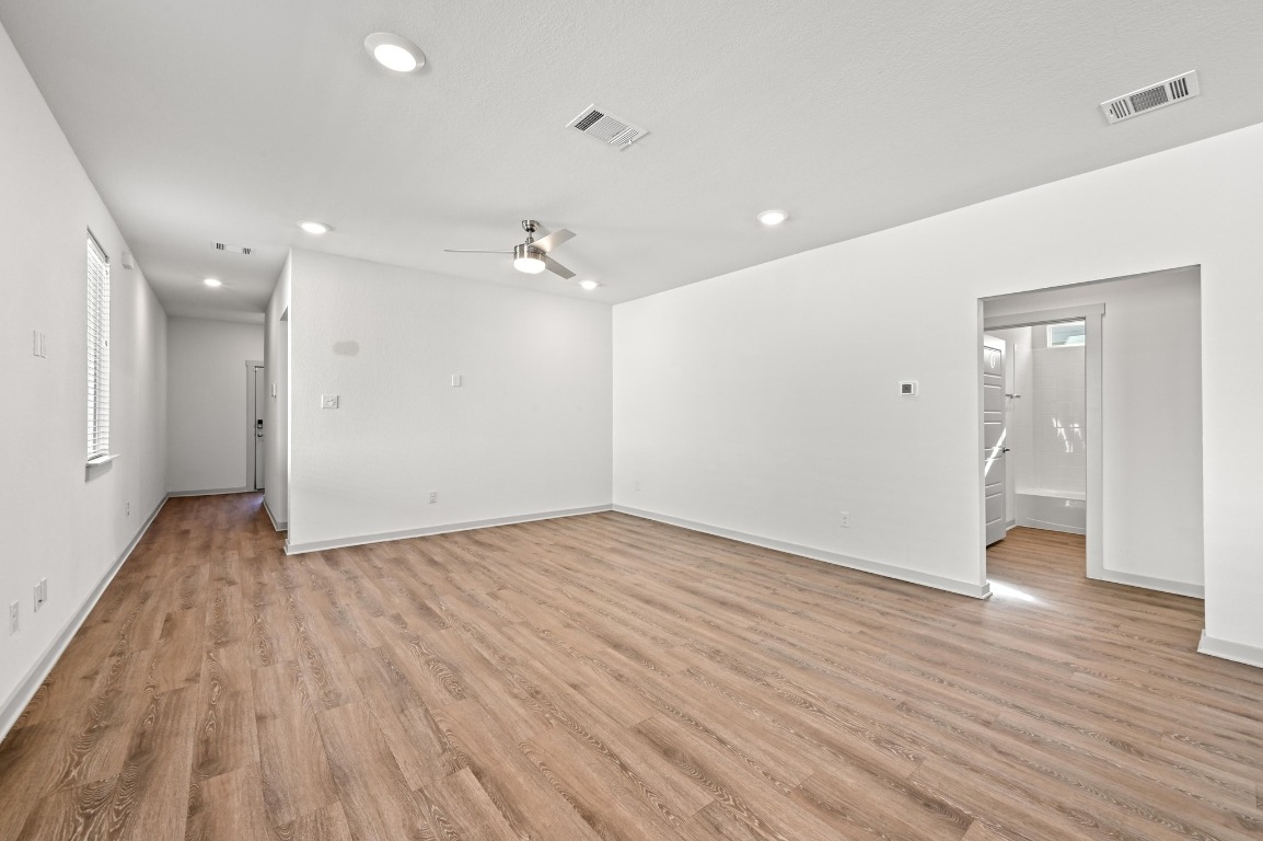 407 Wilshire Road San Marcos, TX 78666 - Photo 10 of 25 a view of an empty room with wooden floor and a window