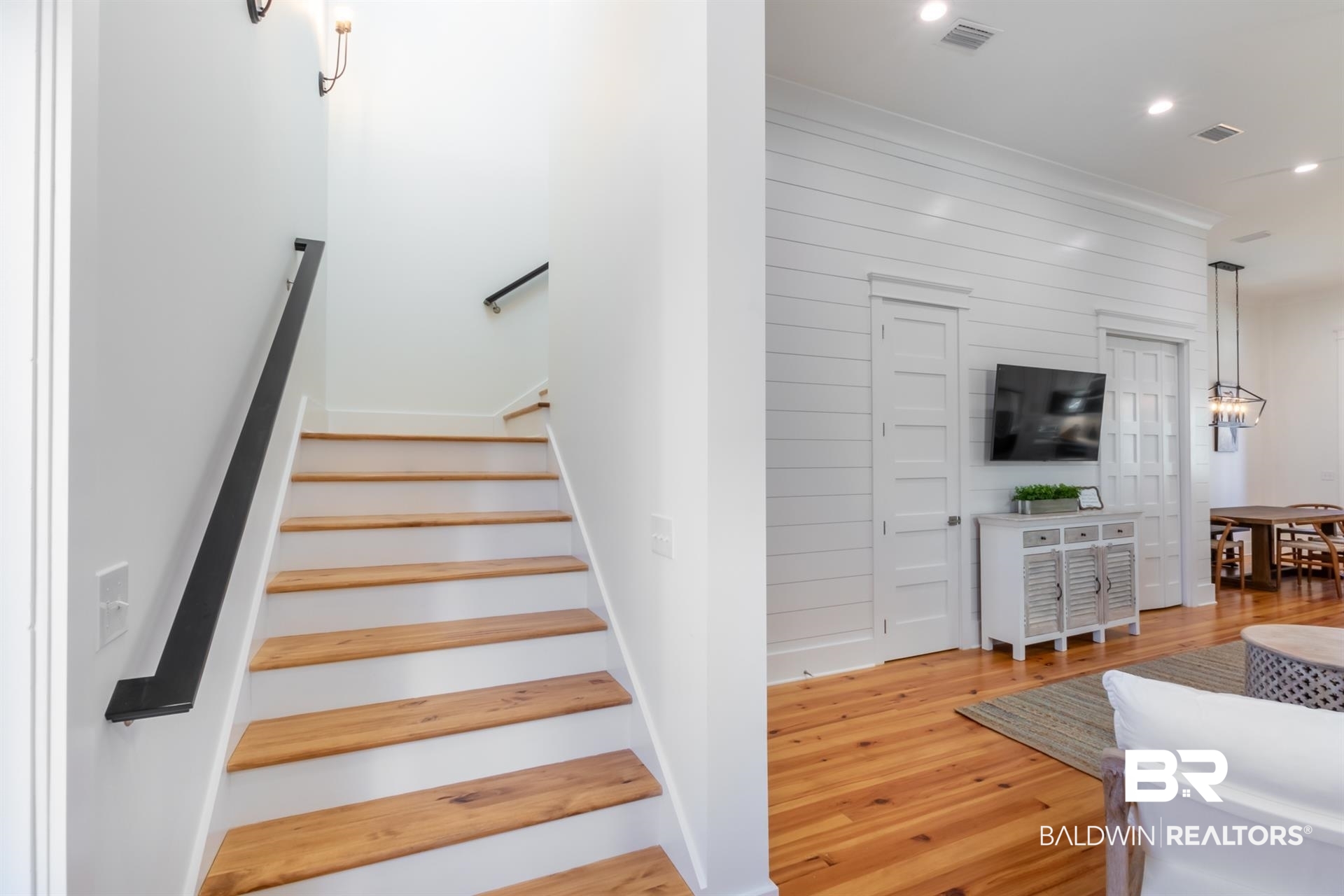 2494 Saltgrass Way Orange Beach, AL 36561 - Photo 13 of 37 Stairway featuring wood-type flooring and wooden walls