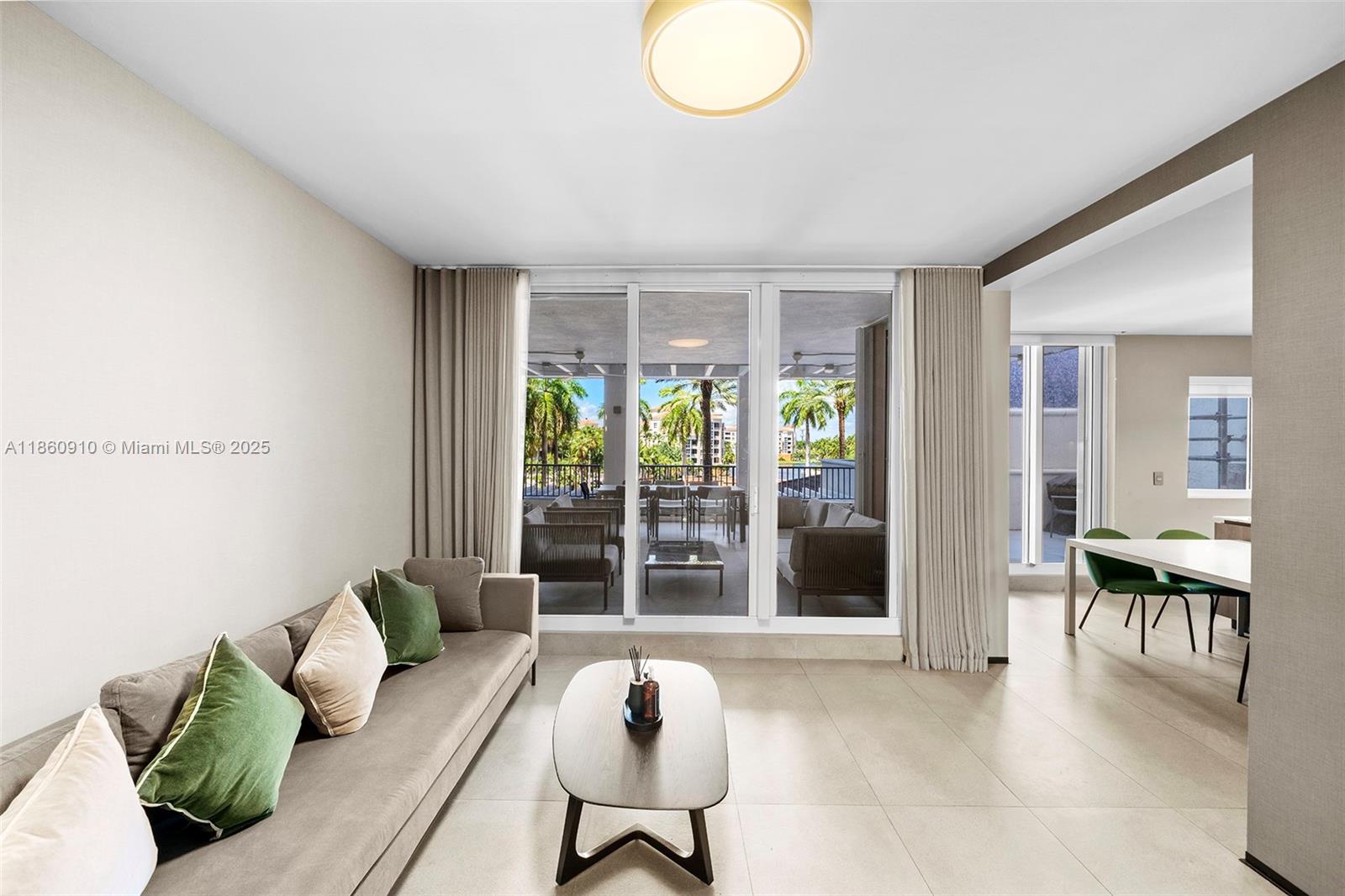 785 Crandon Boulevard, Unit 303 Key Biscayne, FL 33149 - Photo 13 of 57 a living room with furniture and a large window