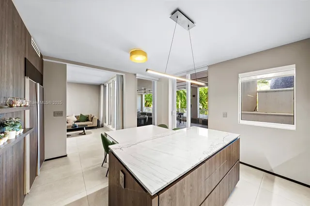 a bedroom with furniture and a large window