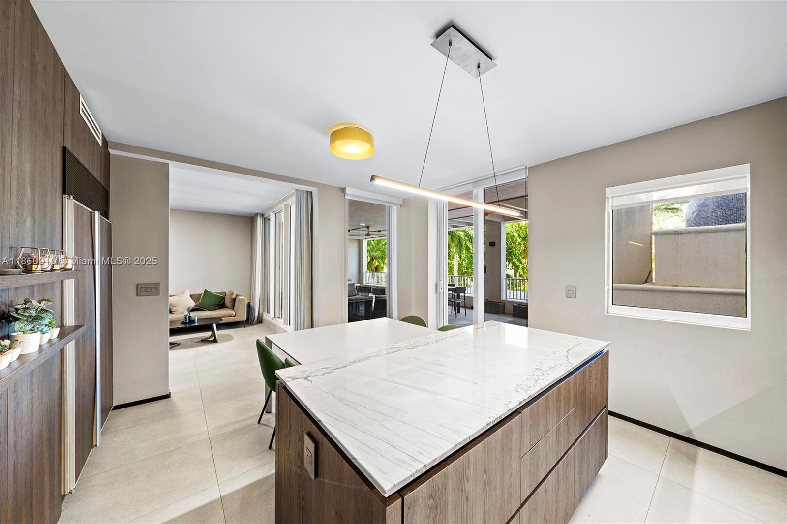 785 Crandon Boulevard, Unit 303 Key Biscayne, FL 33149 - Photo 17 of 57 a kitchen with a table and chairs