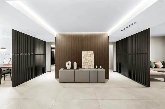 a view of a hallway with furniture and floor to ceiling window