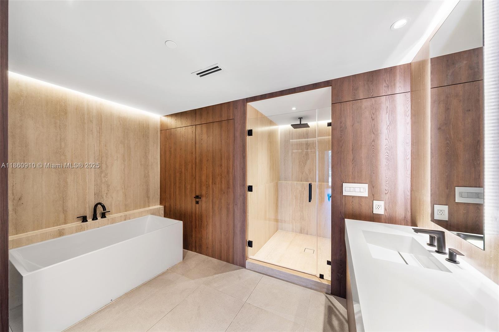 785 Crandon Boulevard, Unit 303 Key Biscayne, FL 33149 - Photo 25 of 57 a bathroom with a tub sink and mirror