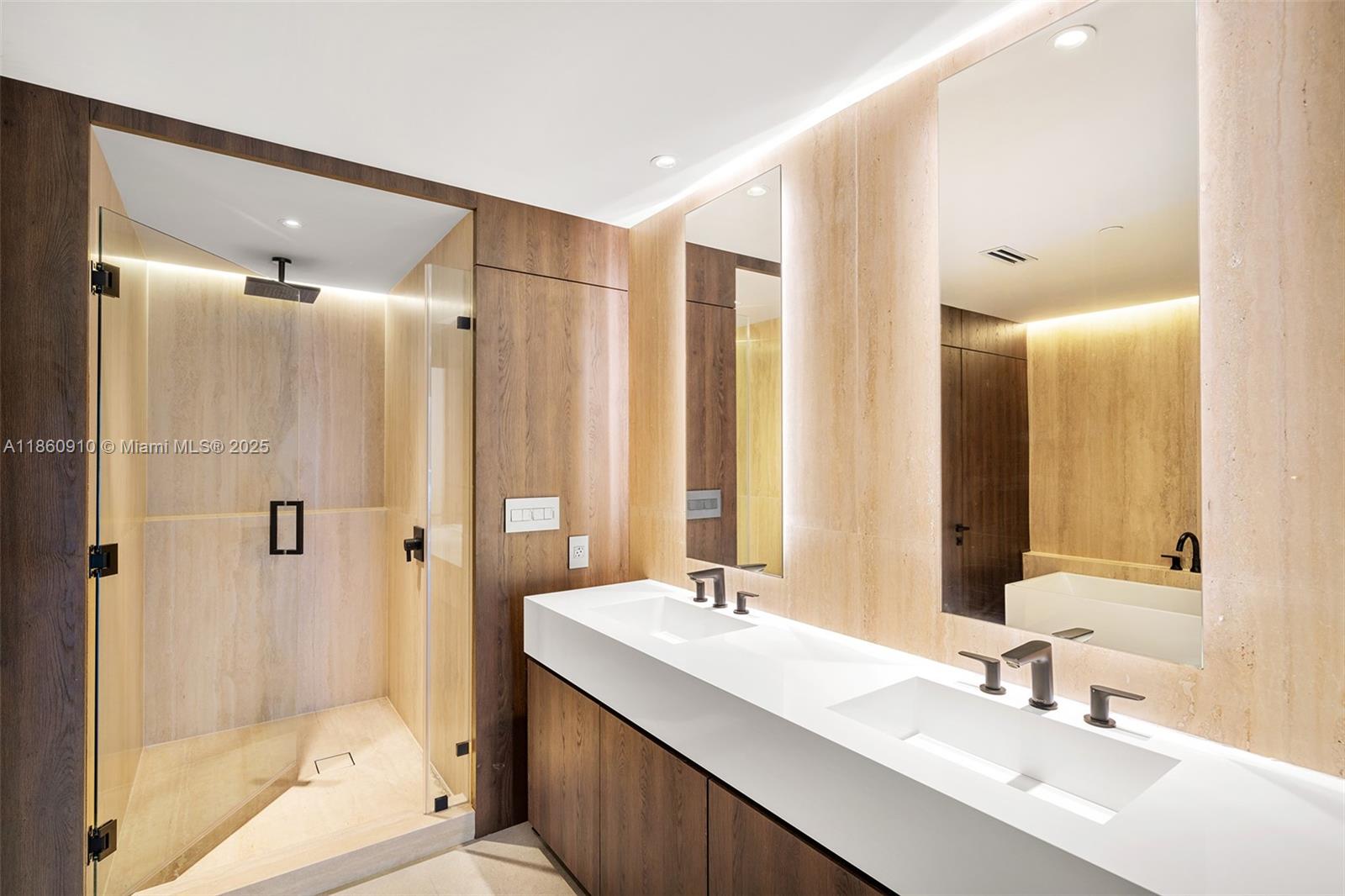 785 Crandon Boulevard, Unit 303 Key Biscayne, FL 33149 - Photo 26 of 57 a bathroom with a double vanity sink mirror double and shower