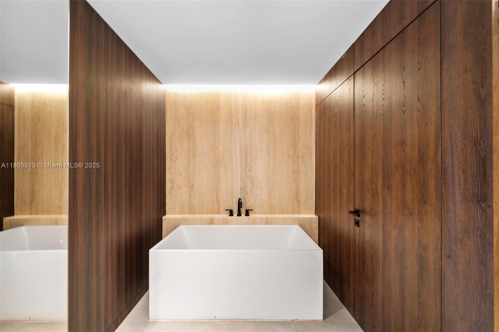 785 Crandon Boulevard, Unit 303 Key Biscayne, FL 33149 - Photo 27 of 57 a spacious bathroom with a bathtub and a shower