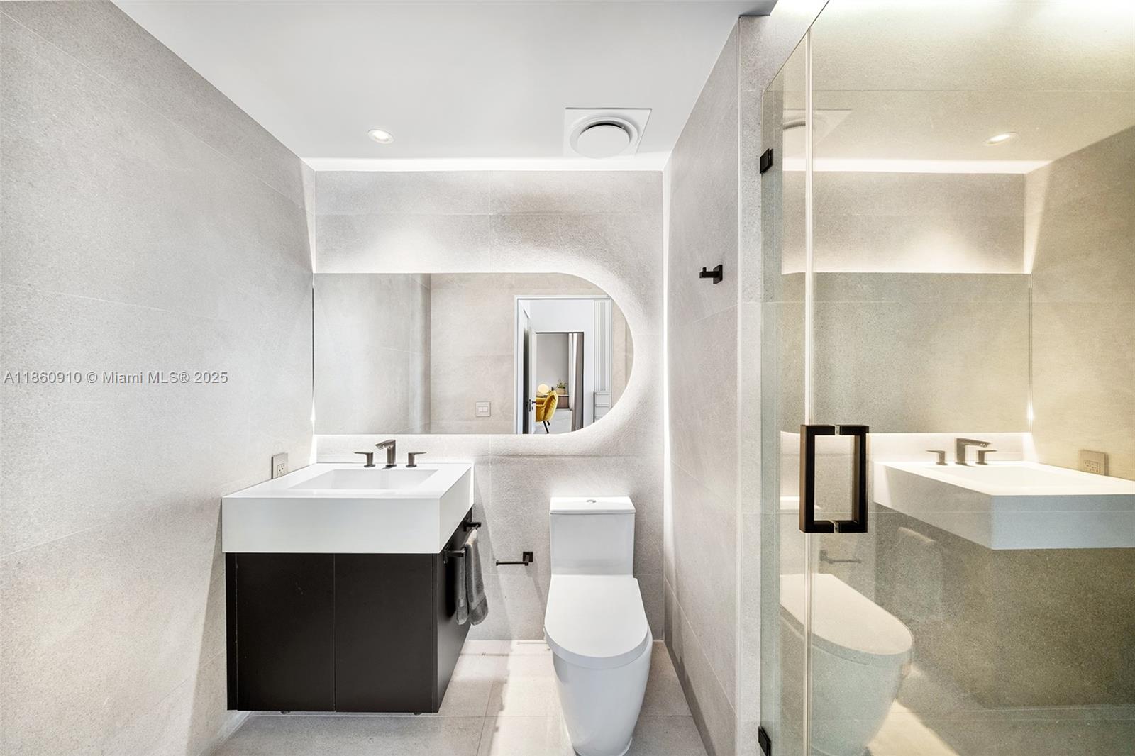 785 Crandon Boulevard, Unit 303 Key Biscayne, FL 33149 - Photo 31 of 57 a bathroom with a sink toilet and mirror