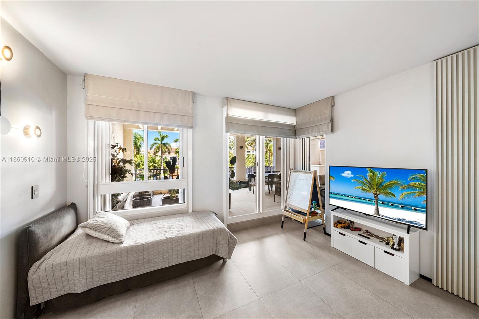 785 Crandon Boulevard, Unit 303 Key Biscayne, FL 33149 - Photo 32 of 57 a living room with furniture and a flat screen tv