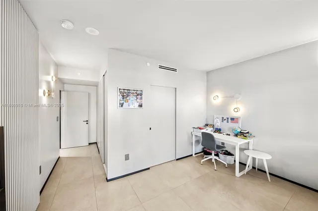 a view of a balcony with a couple of flower plants and wooden fence
