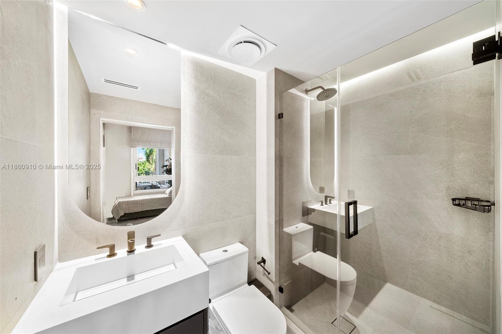 785 Crandon Boulevard, Unit 303 Key Biscayne, FL 33149 - Photo 37 of 57 a bathroom with a sink toilet and shower