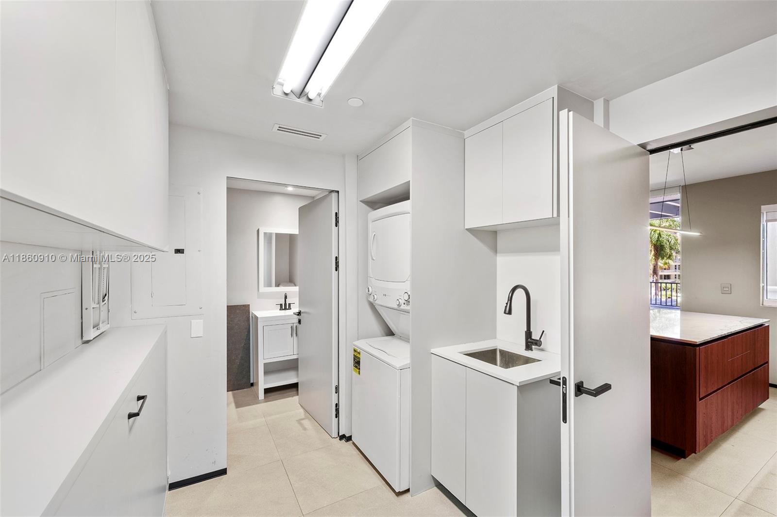 785 Crandon Boulevard, Unit 303 Key Biscayne, FL 33149 - Photo 38 of 57 a bathroom with a double vanity sink mirror and shower