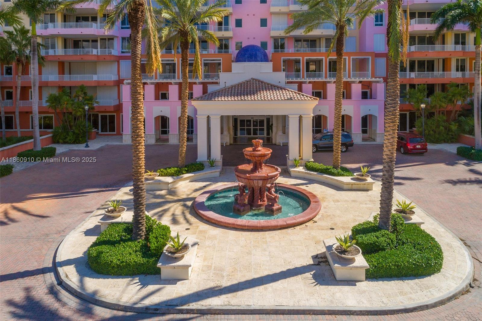 785 Crandon Boulevard, Unit 303 Key Biscayne, FL 33149 - Photo 39 of 57 a front view of a building with a garden and plants
