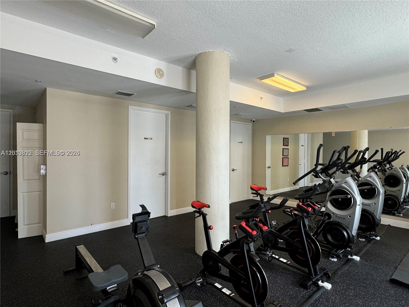 115 Southwest 11th Street, Unit 707 Miami, FL 33130 - Photo 13 of 25 a view of a room with gym equipment