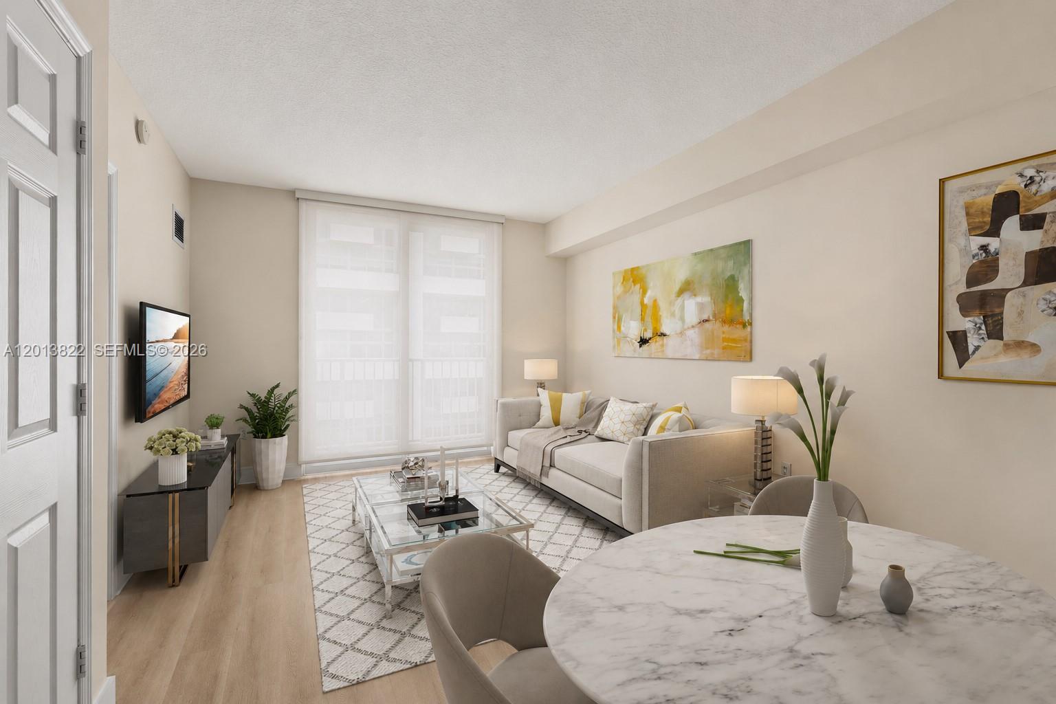 115 Southwest 11th Street, Unit 707 Miami, FL 33130 - Photo 2 of 25 a living room with furniture window and a flat screen tv
