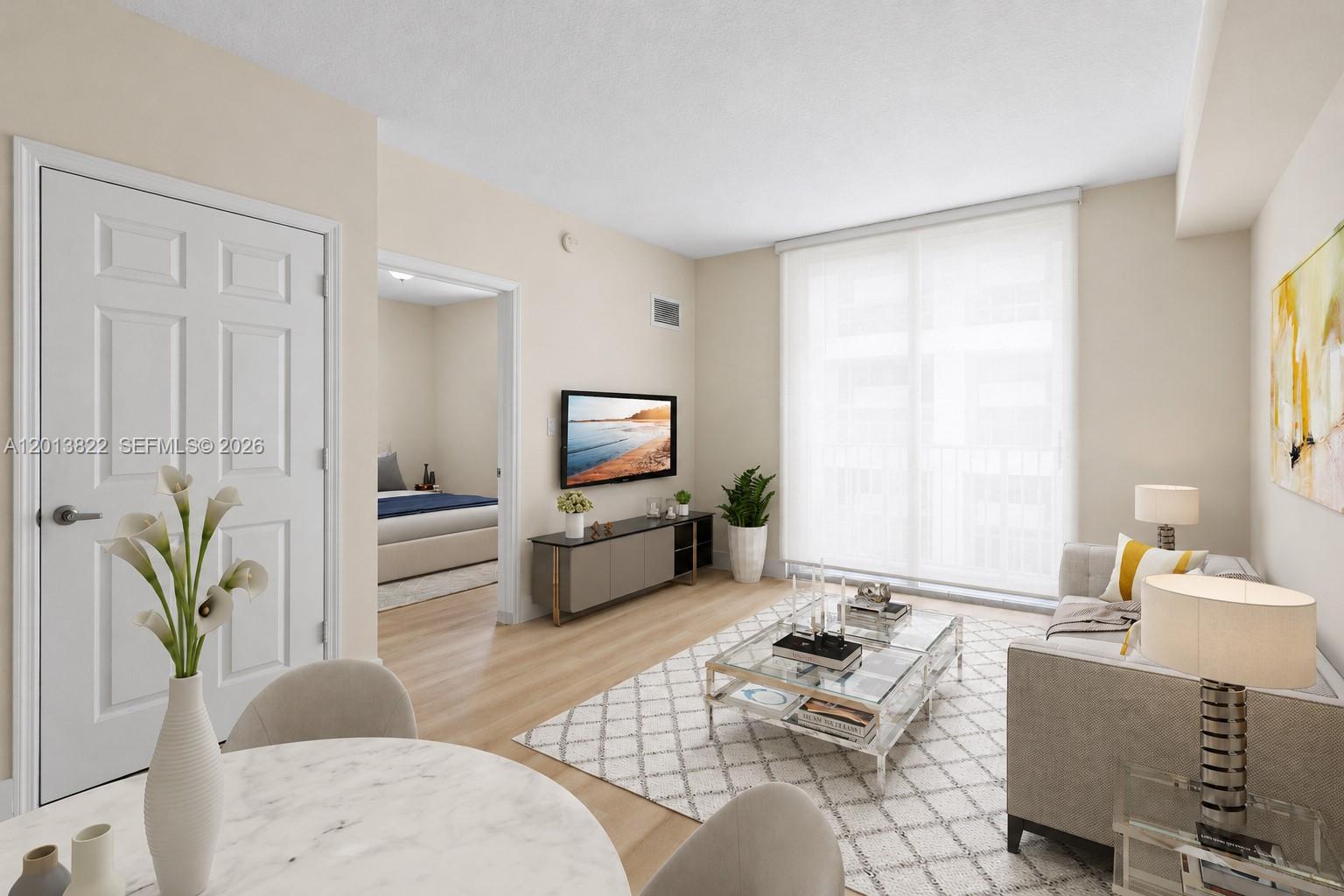 115 Southwest 11th Street, Unit 707 Miami, FL 33130 - Photo 3 of 25 a living room with furniture and a flat screen tv