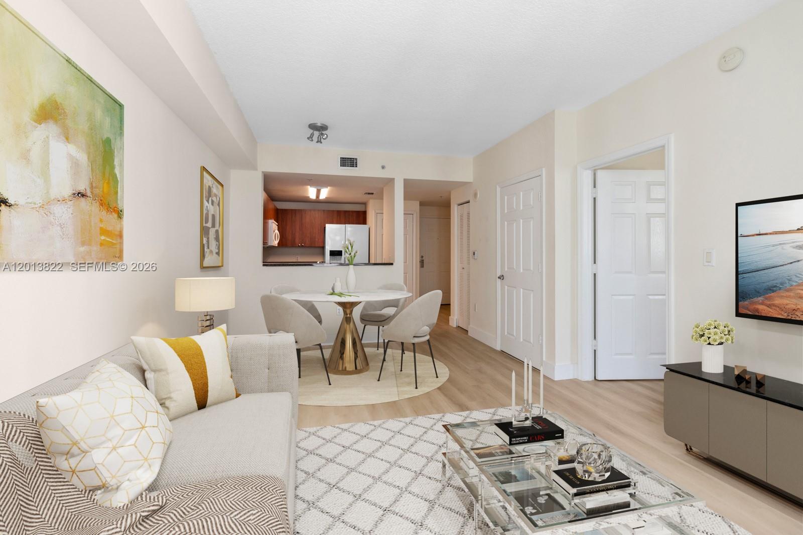 115 Southwest 11th Street, Unit 707 Miami, FL 33130 - Photo 4 of 25 a living room with furniture and a flat screen tv