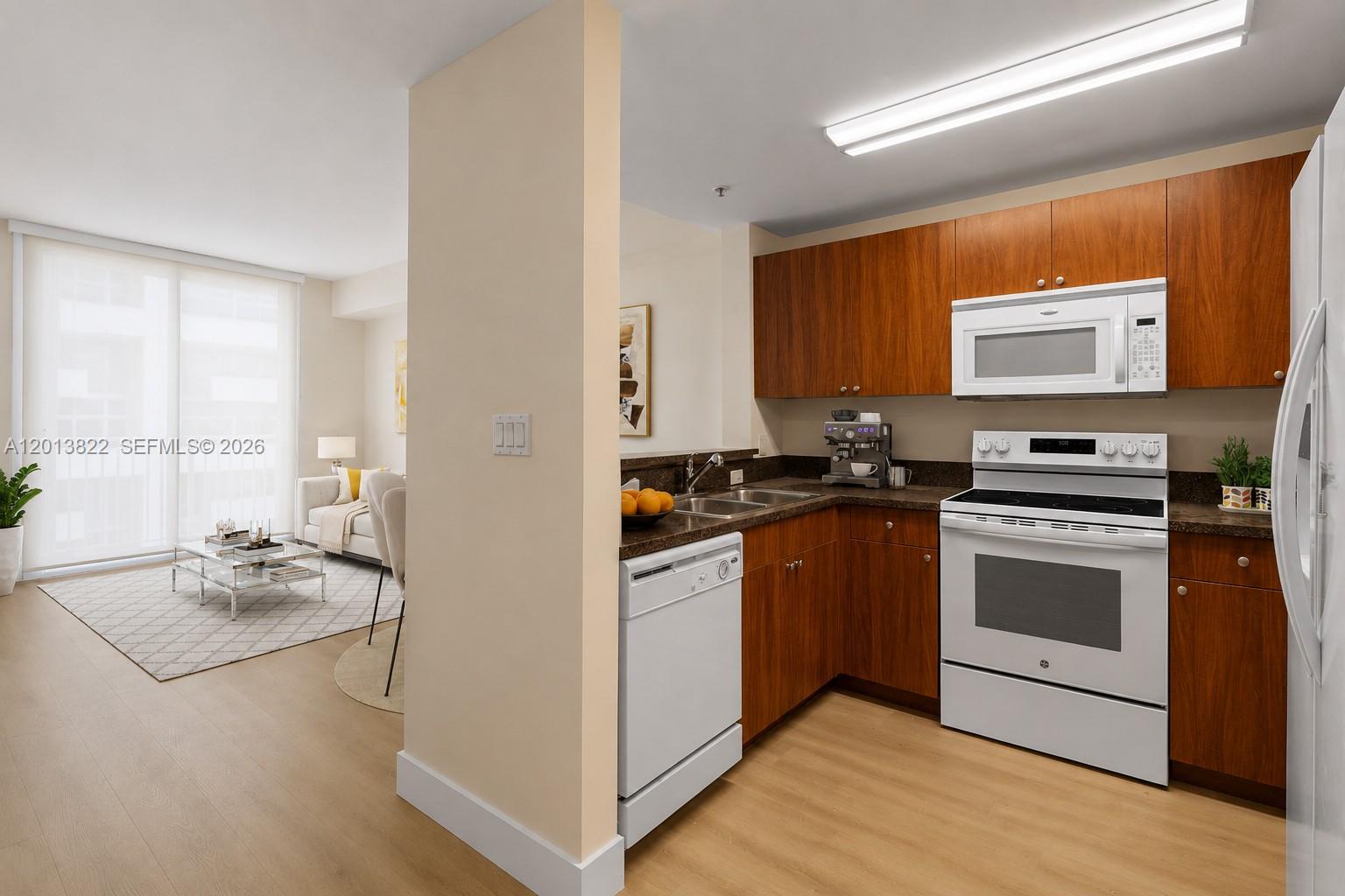 115 Southwest 11th Street, Unit 707 Miami, FL 33130 - Photo 5 of 25 a kitchen with stainless steel appliances a stove a sink and a refrigerator