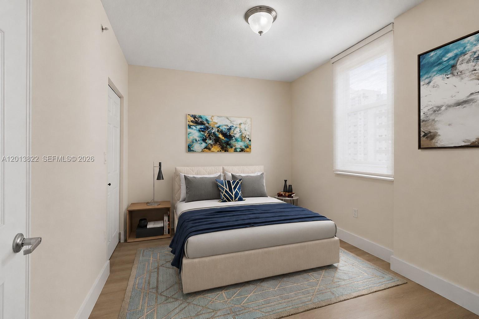 115 Southwest 11th Street, Unit 707 Miami, FL 33130 - Photo 8 of 25 a bedroom with a bed and a painting on the wall
