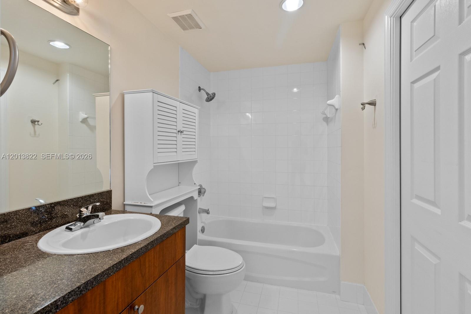 115 Southwest 11th Street, Unit 707 Miami, FL 33130 - Photo 10 of 25 a bathroom with a sink double vanity granite tub and a mirror