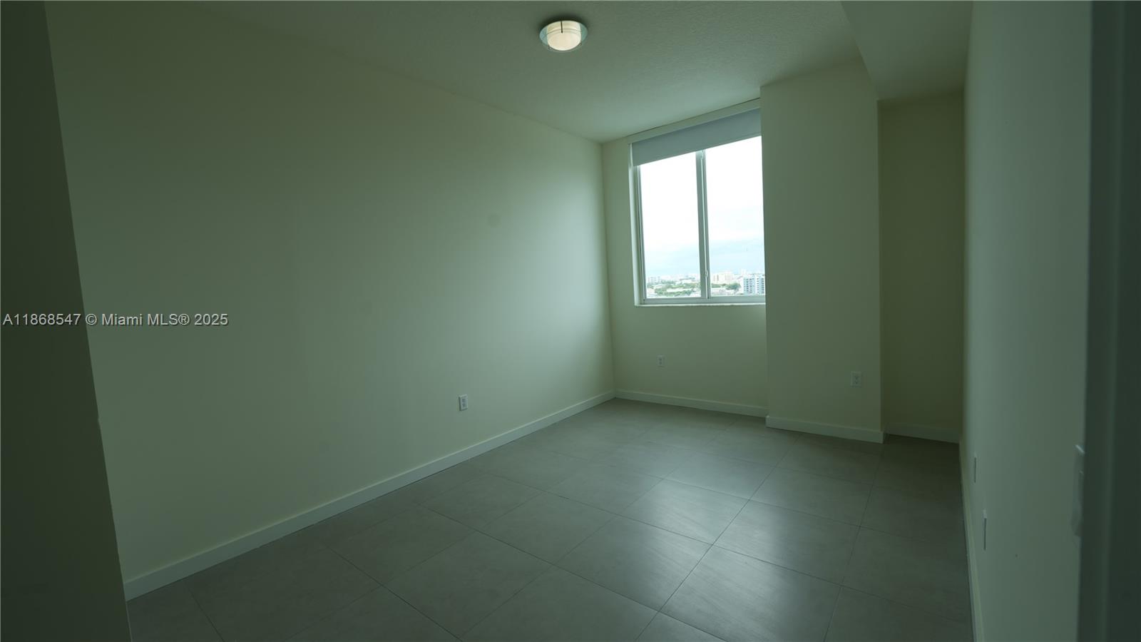 729 Northwest 2nd Street, Unit 717 Miami, FL 33128 - Photo 11 of 25 an empty room with a window