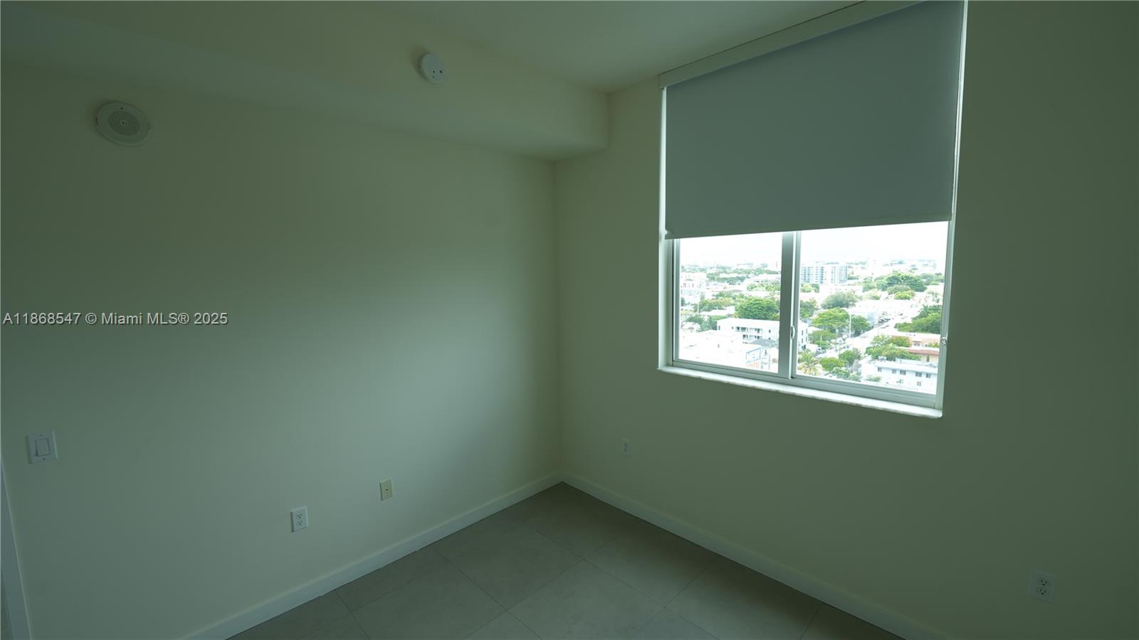 729 Northwest 2nd Street, Unit 717 Miami, FL 33128 - Photo 16 of 25 a view of an empty room with a window