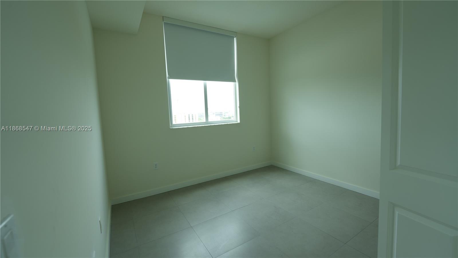 729 Northwest 2nd Street, Unit 717 Miami, FL 33128 - Photo 22 of 25 a view of an empty room with a window