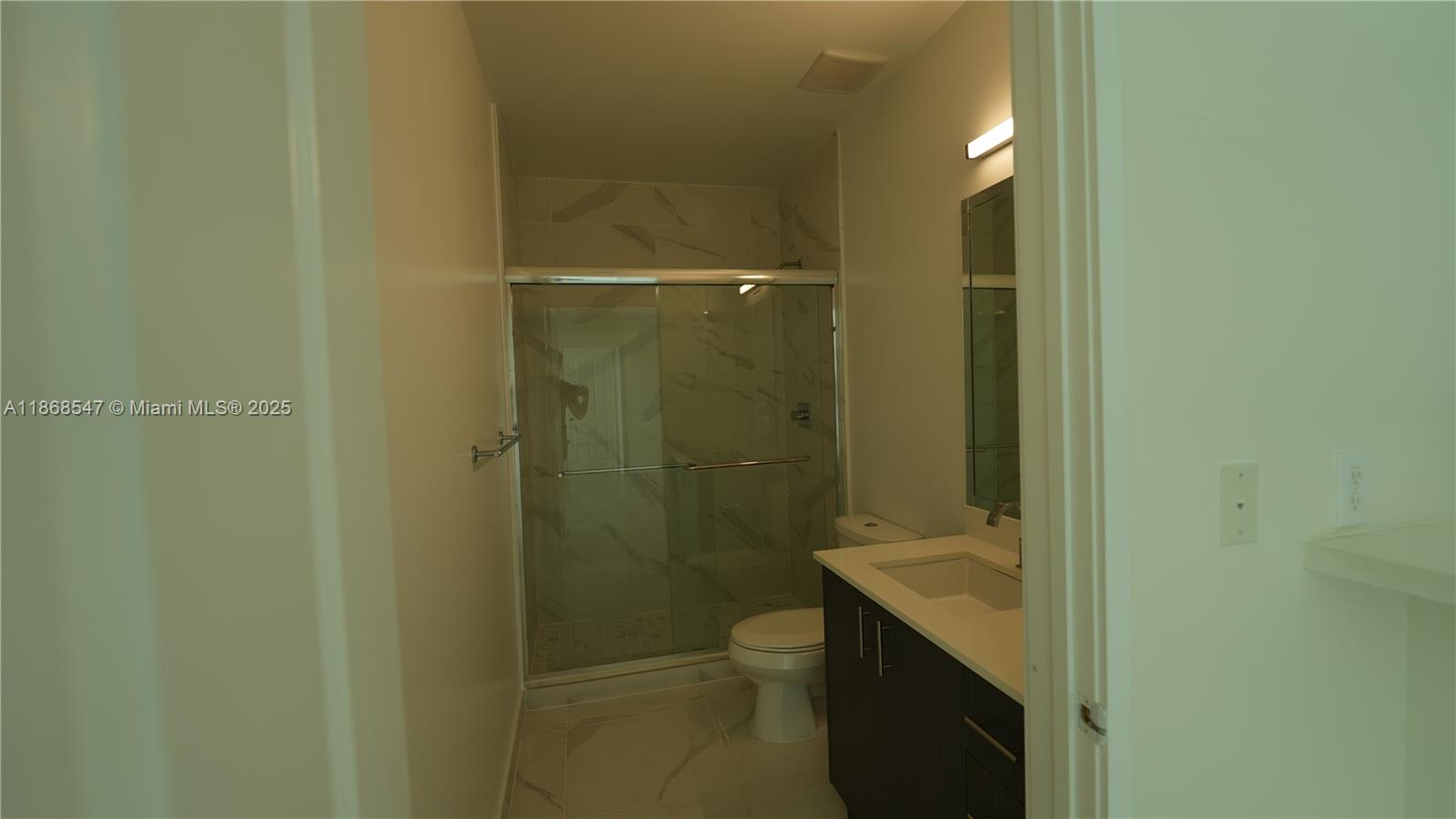 729 Northwest 2nd Street, Unit 717 Miami, FL 33128 - Photo 25 of 25 a bathroom with a granite countertop sink toilet and shower