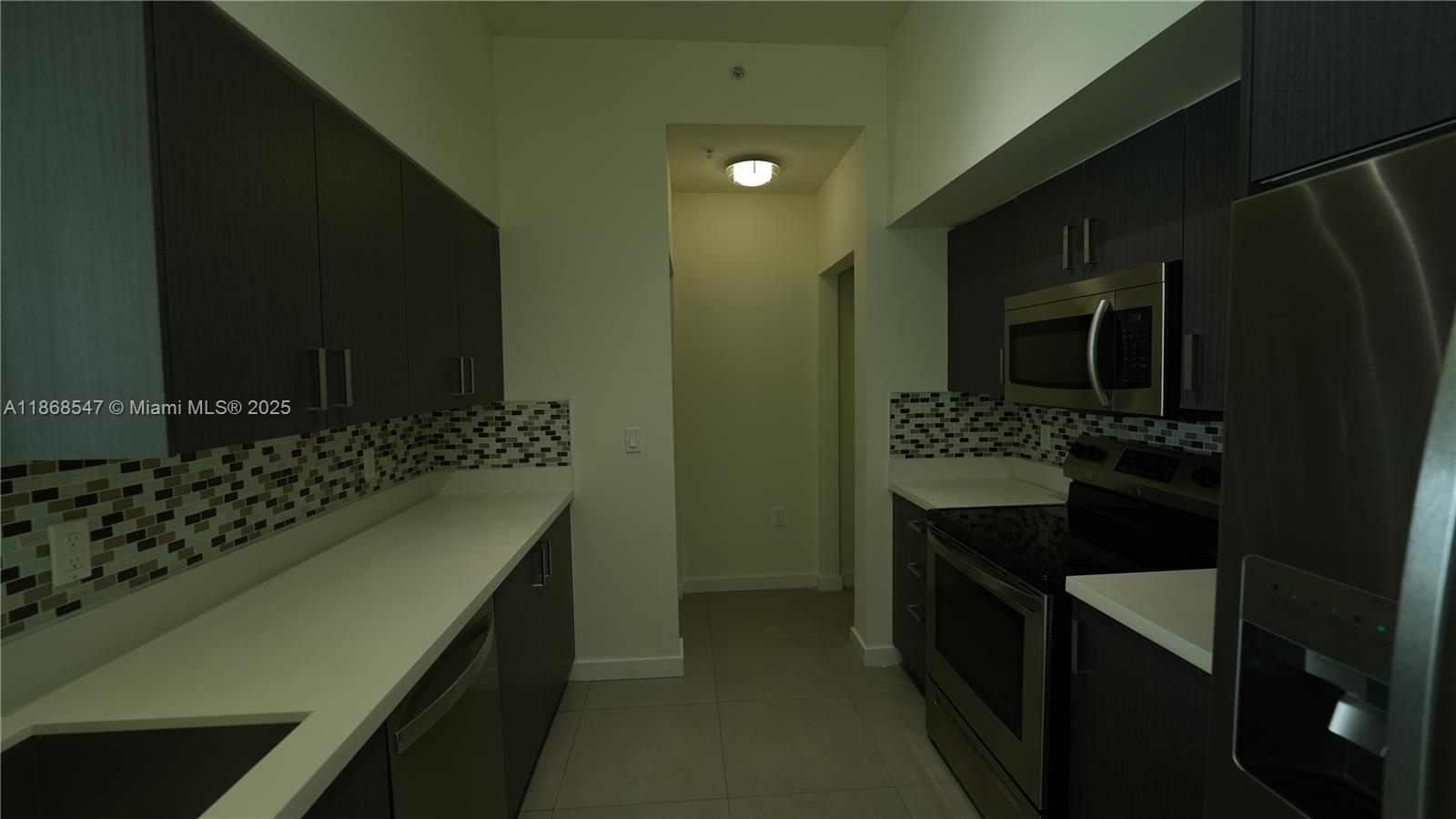 729 Northwest 2nd Street, Unit 717 Miami, FL 33128 - Photo 3 of 25 a kitchen with a sink and cabinets
