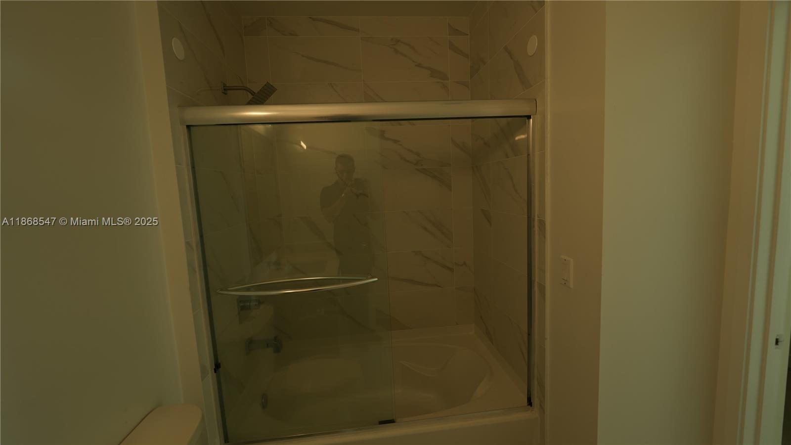 729 Northwest 2nd Street, Unit 717 Miami, FL 33128 - Photo 7 of 25 a bathroom with a glass shower door