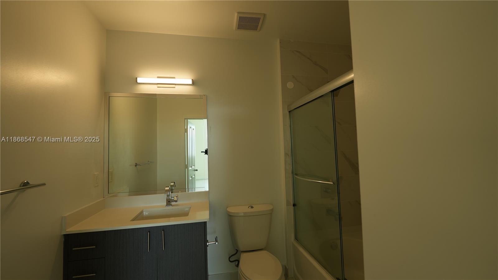 729 Northwest 2nd Street, Unit 717 Miami, FL 33128 - Photo 9 of 25 a bathroom with a sink a toilet and shower