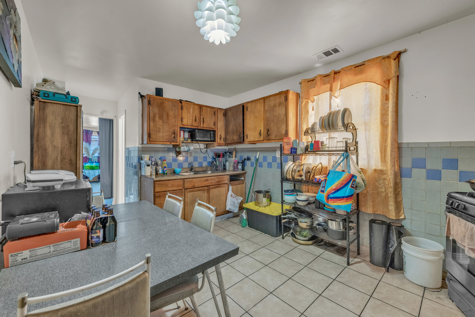 5114 South Justine Street Chicago, IL 60609 - Photo 20 of 37 a living room filled with furniture and a chandelier