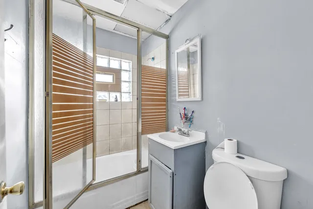 a kitchen with a refrigerator and a stove top oven