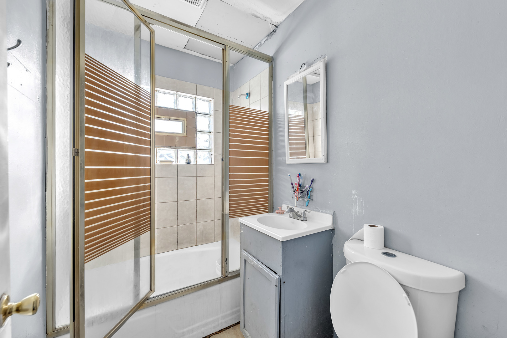 5114 South Justine Street Chicago, IL 60609 - Photo 8 of 37 a bathroom with a sink a toilet and shower
