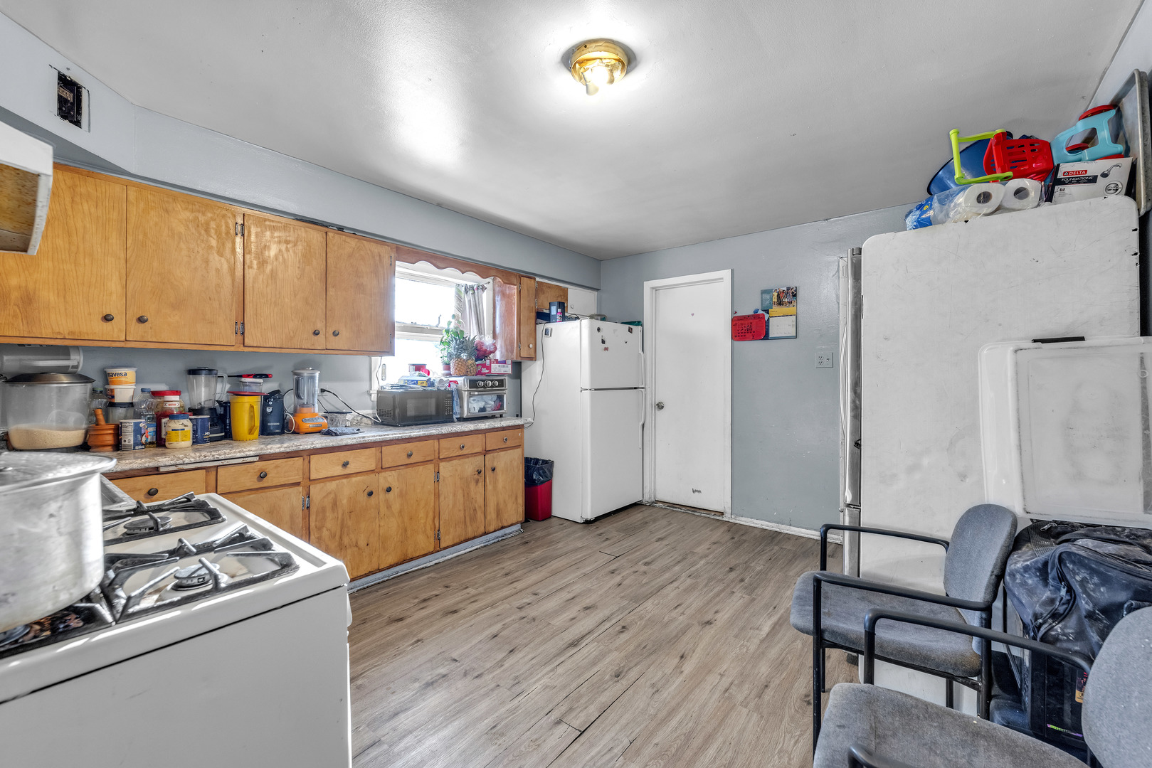 5114 South Justine Street Chicago, IL 60609 - Photo 9 of 37 a kitchen with a refrigerator and a stove top oven