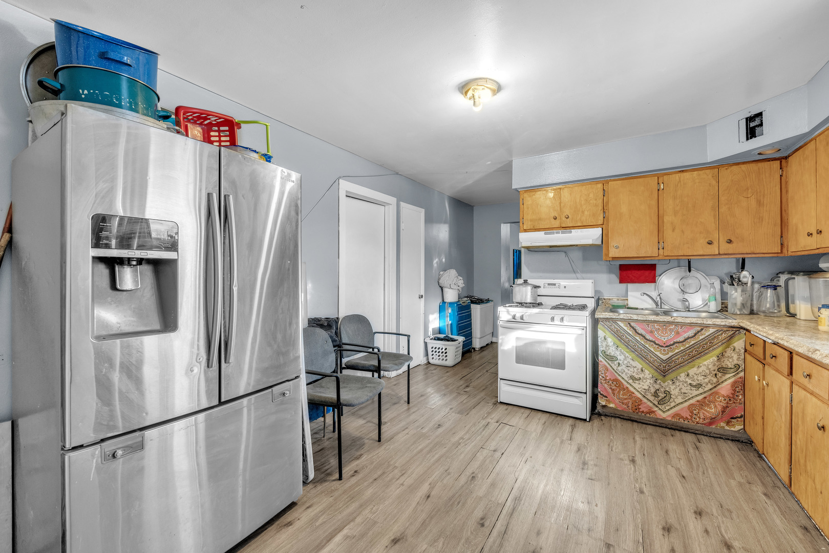 5114 South Justine Street Chicago, IL 60609 - Photo 10 of 37 a kitchen with stainless steel appliances a refrigerator sink and wooden floor