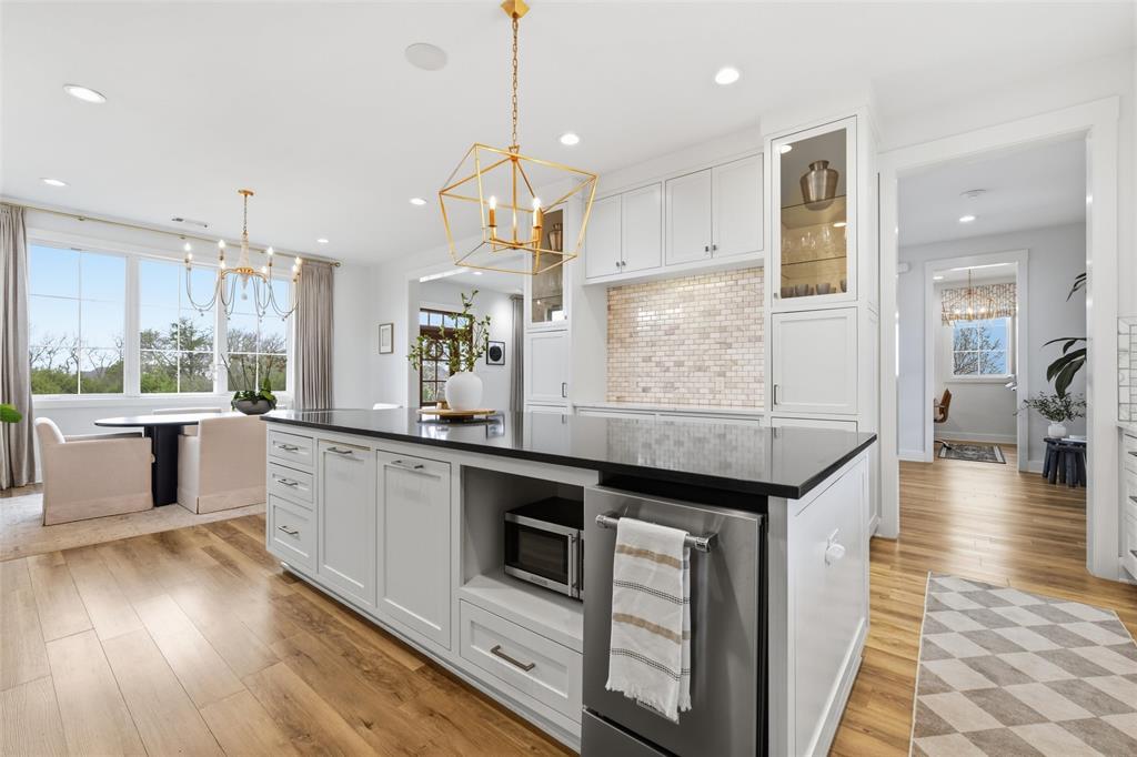 17001 Escondida Court Woodway, TX 76712 - Photo 14 of 40 a large kitchen with stainless steel appliances kitchen island granite countertop a large counter top and sink