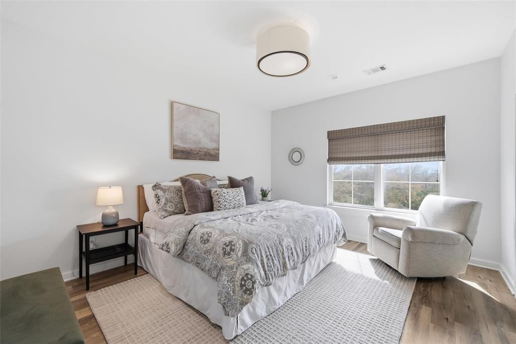 17001 Escondida Court Woodway, TX 76712 - Photo 26 of 40 a bedroom with a bed and wooden floor