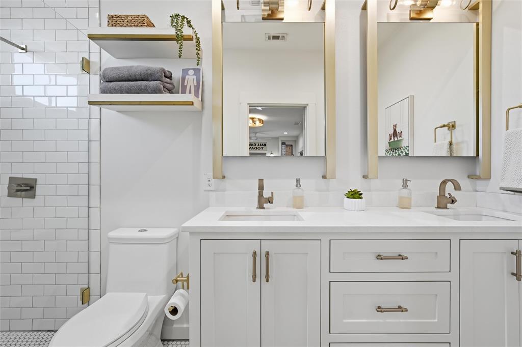 17001 Escondida Court Woodway, TX 76712 - Photo 29 of 40 a bathroom with a granite countertop toilet sink and mirror