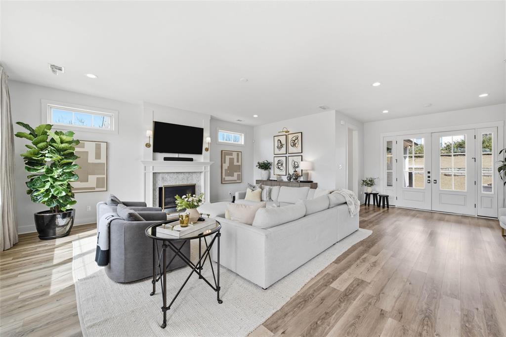 17001 Escondida Court Woodway, TX 76712 - Photo 5 of 40 a living room with furniture a fireplace and a flat screen tv
