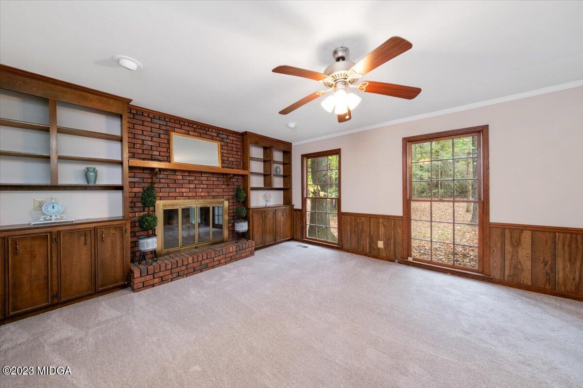 1434 Craddock Way Macon, GA 31210 - Photo 11 of 32 a view of an empty room with a fireplace and a window