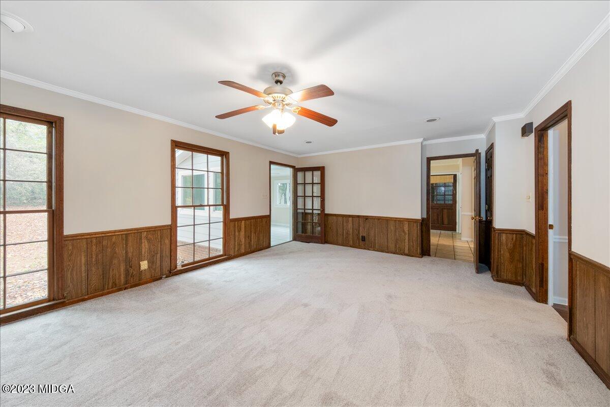 1434 Craddock Way Macon, GA 31210 - Photo 12 of 32 an empty room with chandelier fan and windows