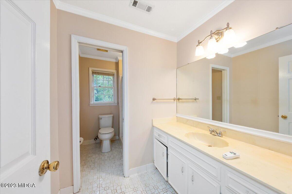1434 Craddock Way Macon, GA 31210 - Photo 23 of 32 a spacious bathroom with a granite countertop sink mirror and a toilet