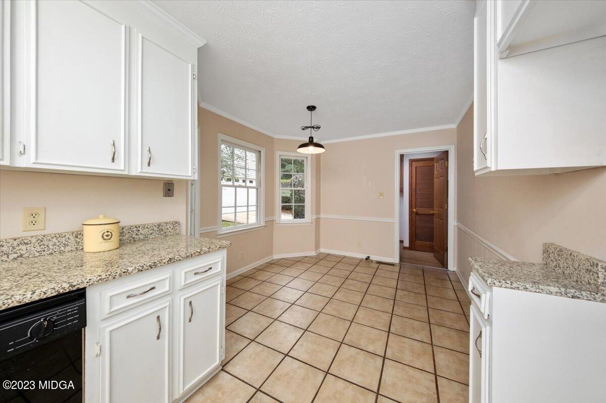1434 Craddock Way Macon, GA 31210 - Photo 5 of 32 a kitchen with granite countertop a sink stove and cabinets